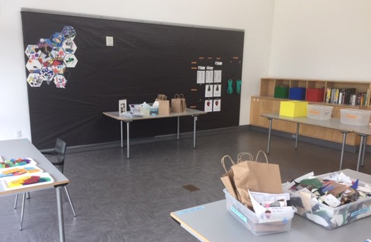 Prep tables in the back of the Art Studio with materials on each.