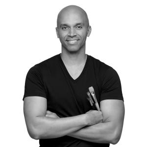 Headshot of Kadir Nelson holding brushes