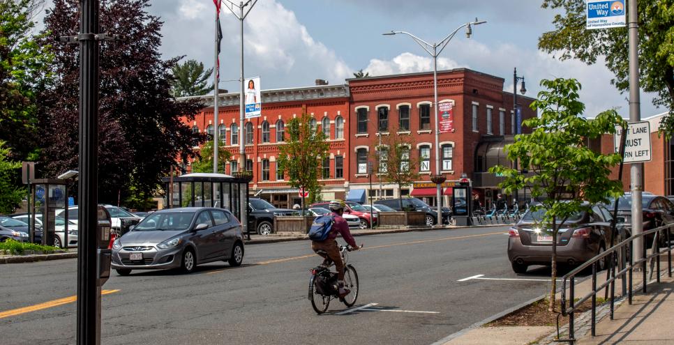 Downtown Amherst with a person on a bike.