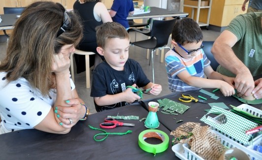 Guests setting up collage papers to construct their mobiles